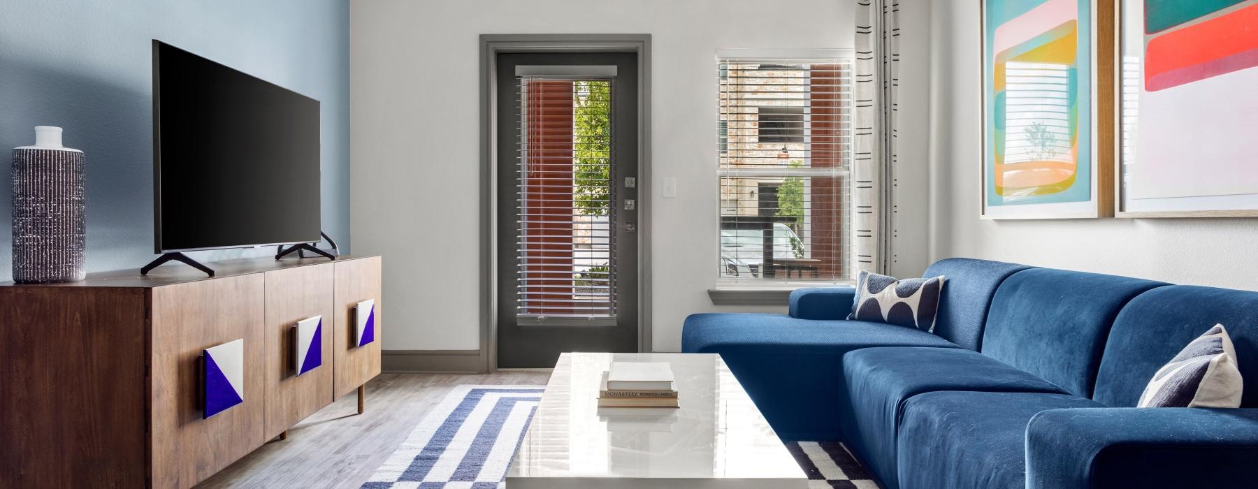 a living room with blue couches