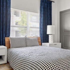 a bedroom with a bed and lamps