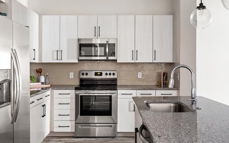 a kitchen with white cabinets