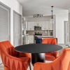 a dining room with orange chairs