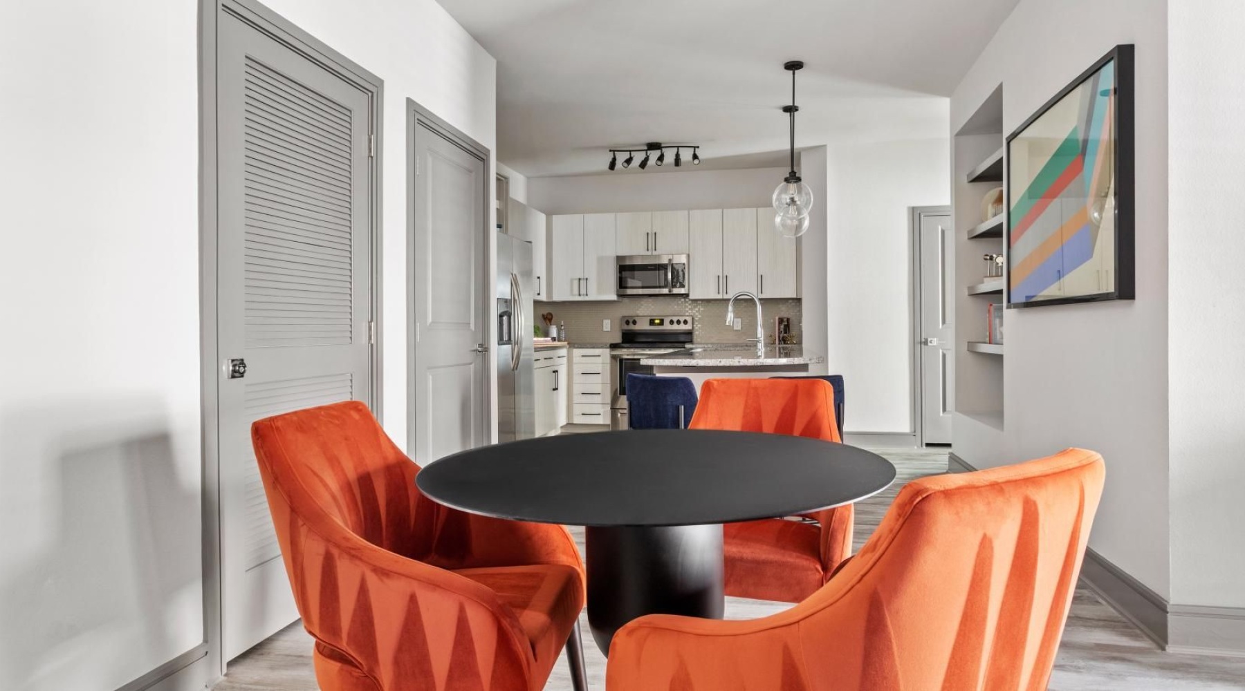 a dining room with orange chairs